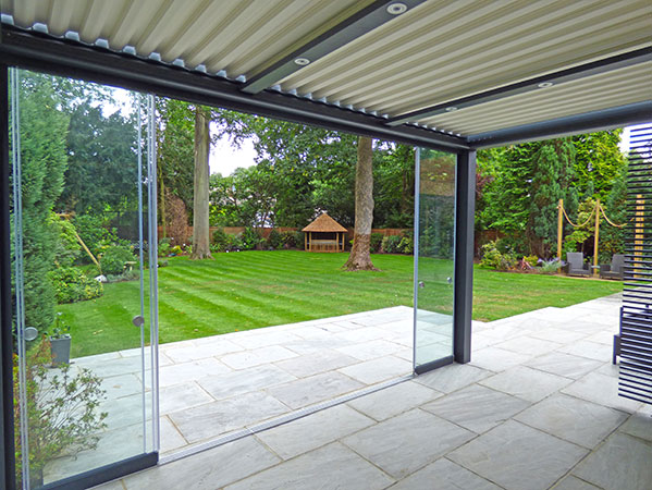 View from patio shelter looking towards Julian Christian Summer house at garden rear