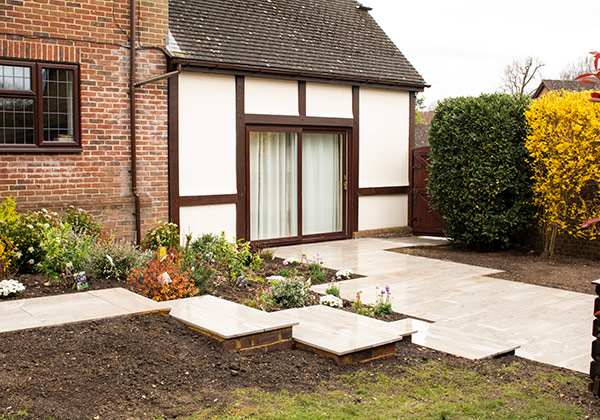 Close up of steps descending at side of house with new planting